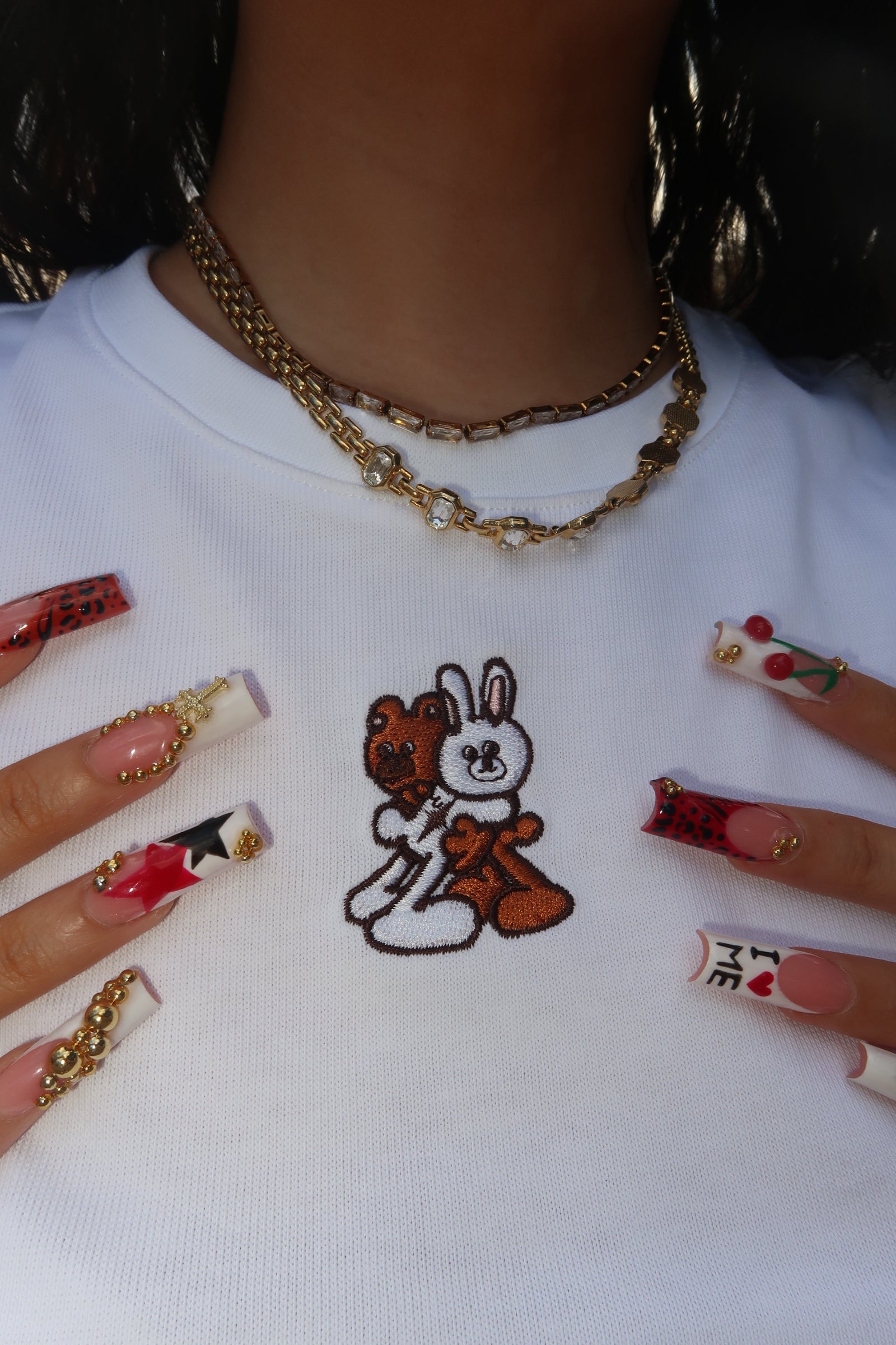 A white kohz crewneck bb crop t-shirt with embroidery on the chest.