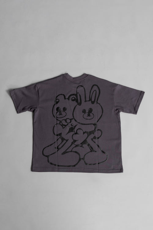 Back of grey oversized crewneck t-shirt with ribbed sleeves and a puff printed logo on the chest.