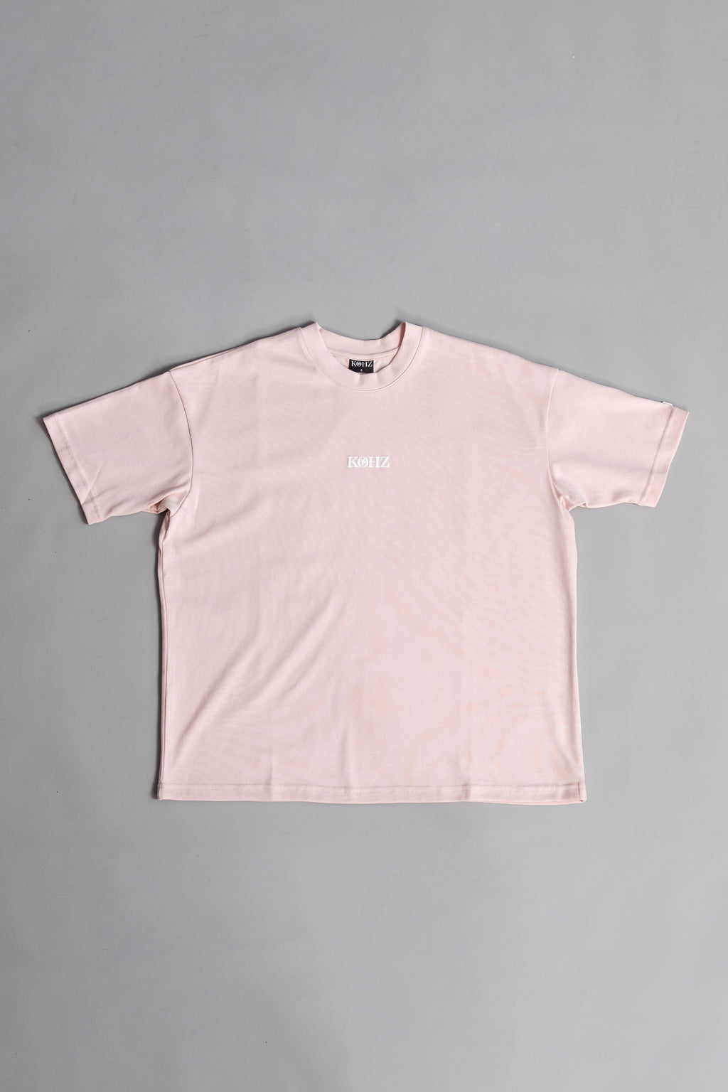 Front of Pink oversized crewneck t-shirt with ribbed sleeves and a puff printed logo on the chest.