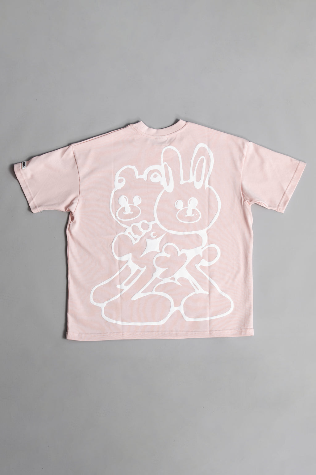 Back of Pink oversized crewneck t-shirt with ribbed sleeves and a puff printed logo on the chest.